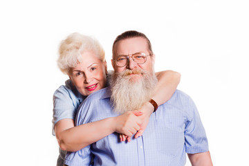 Old woman hugging old man with a beard on a white background