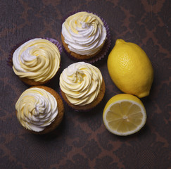 delicious freshly baked homemade lemon muffins cupcakes with butter cream onl, copy space