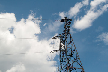 High-voltage electric main against the dark blue sky