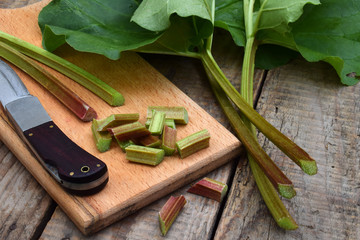 bunch of fresh green organic rhubarb on wooden background.
