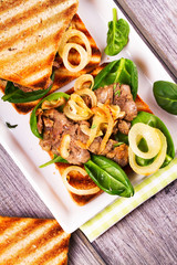Chicken Liver, Spinach and Onion Sandwiches on White Plate. View from above, top studio shot