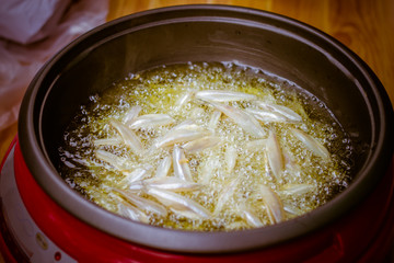  close up of fried small fish in pan sale at asian street market ,cooking style asian, asian kitchen