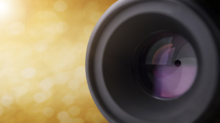 closeup camera lens with blurred bokeh light background.