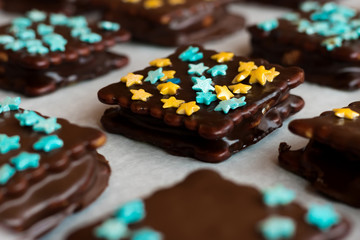 Cookies with marshmallows in chocolate glaze and decorative asterisks