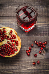 fresh pomegranate juice in a glass the top view/fresh pomegranate juice and the scattered pomegranate grains