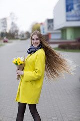 Pretty girl in coat with flowers