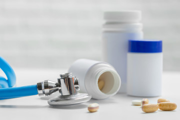  pills or capsules and stethoscope on the white table. Concept healthcare.