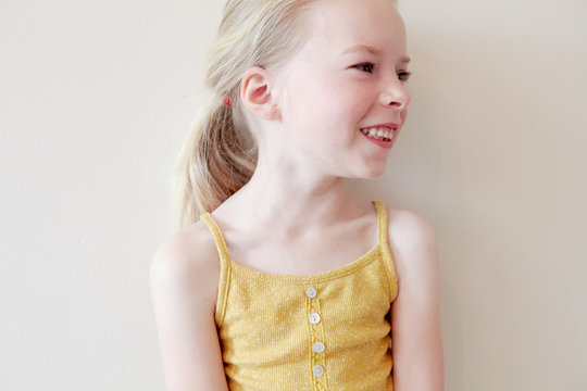 Young girl smiling, looking away