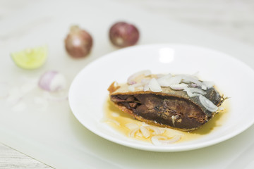 Fish dry fired with lemon and shallot.