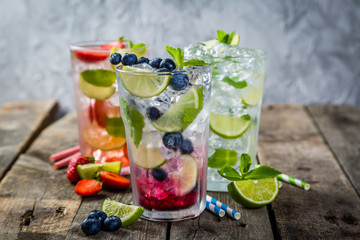 Selection of colorful mojitoes in glasses