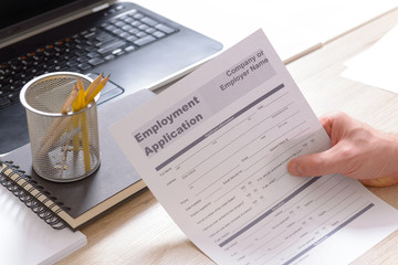 Holding blank employment application form