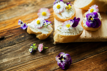 Canapes with avocado paste and edible flowers