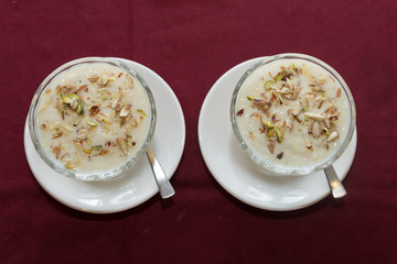 Indian sweet rabdi in bowl and a underliner