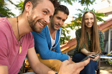 Three friends with cell phone