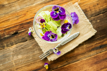 Close up salad leaves garden herbs and edible flowers. Healthy nutrition. Food background