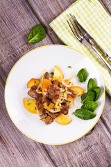 Chicken liver with apple, spinach and onion. View from above, top studio shot