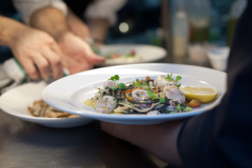 Calamari and pasta dish in restaurant