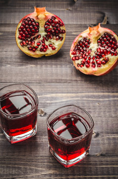 two juice in a glass and pomegranates top view/two juice in a glass and pomegranates