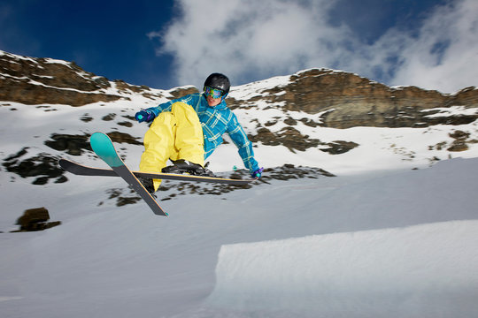 Male skier mid air with crossed skis
