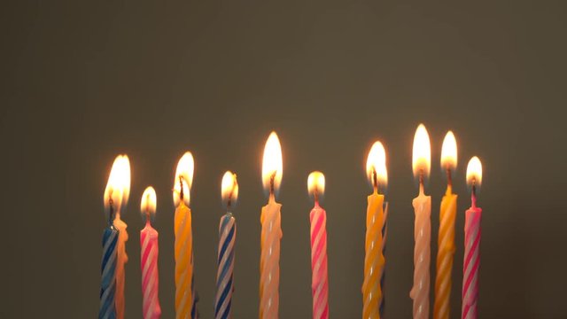 A female hand sets candles for a birthday.