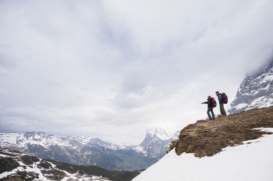 Couple hiking near Klein Scheidegg at the base of mount Eiger, Adelboden, Bernese Oberland, Switzerland