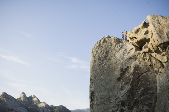 Male,and female climbers on top of "Tribal Boundaries" 5.10a - Flaming Rock, City of Rocks, Idaho, USA