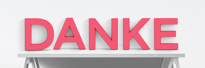 Große Buchstaben auf Tisch mit weißem Hintergrund