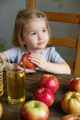 Fototapeta premium Cute little girl holding an apple