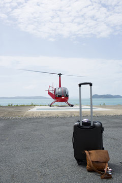 Luggage in front of helicopter preparing to leave from Long Island, Whitsunday Islands, Queensland, Australia