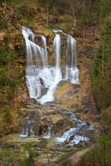Obraz premium Waterfall at stream weissbach in bavaria, germany, vertical, long time exposure