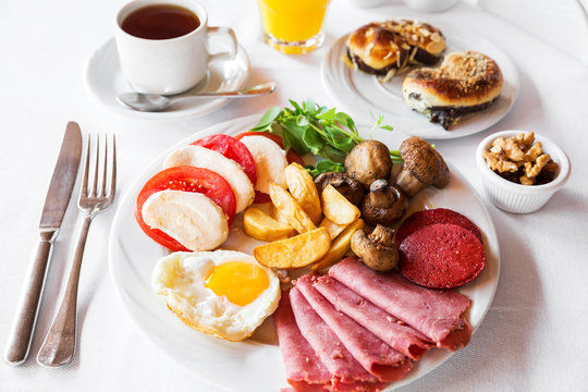 Traditional english breakfast with egg, bacon, mushrooms and tea
