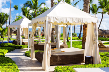 Tropical beach resort with umbrellas and lounge chairs