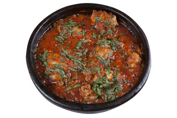 Chicken in Georgian in a spicy tomato sauce on a white background