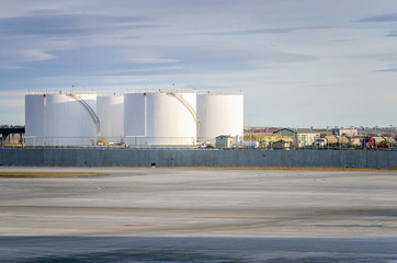 Oil Tanks along the Tarmac in an Airport 