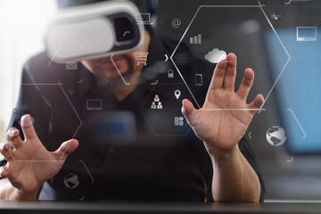 businessman wearing virtual reality goggles in modern office with Smartphone using with VR headset