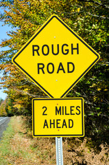 Rough Road Ahead. Warning Traffic Sign on a Mountain Road
