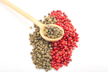 Green and Red Pepper in wood spoon on White Background