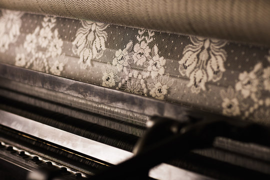 Lace roll on old weaving machine in textile mill