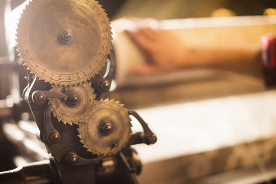 Cogs on old weaving machine in textile mill