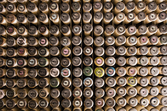 Rows of lace bobbins on old weaving machine in textile mill