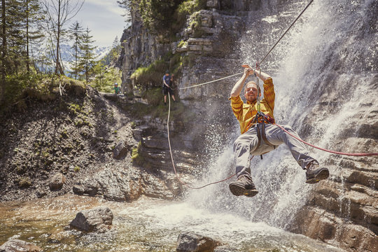Man rappelling waterfall, Ehrwald, Tyrol, Austria