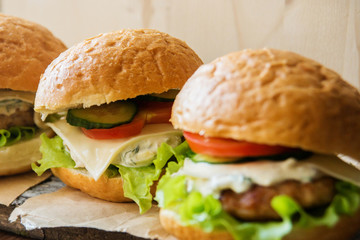 Closeup of home made burgers on wooden background