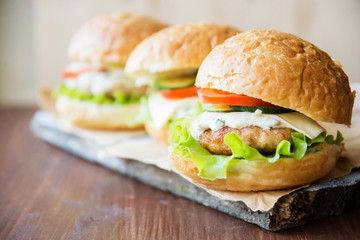 Closeup of home made burgers on wooden background