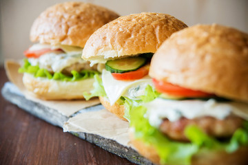 Closeup of home made burgers on wooden background