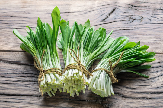 Young fresh wild garlic on the wooden table.