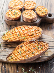 Baked batata on the old wooden table.