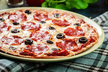 Pizza pepperoni with olives served