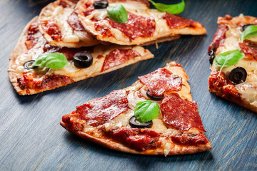 Slices of pizza pepperoni with olives