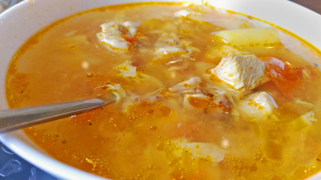 nourishing chicken soup with egg close up