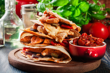 Stack of quesadillas with chicken, sausage chorizo and red peppe